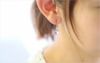  プラチナカラーの純チタンフック使用のピュアハート「アメジスト」、女性の耳につけている画像